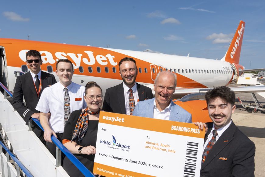 crew of an easyjet plane holding a massive boarding pass to bristol airport