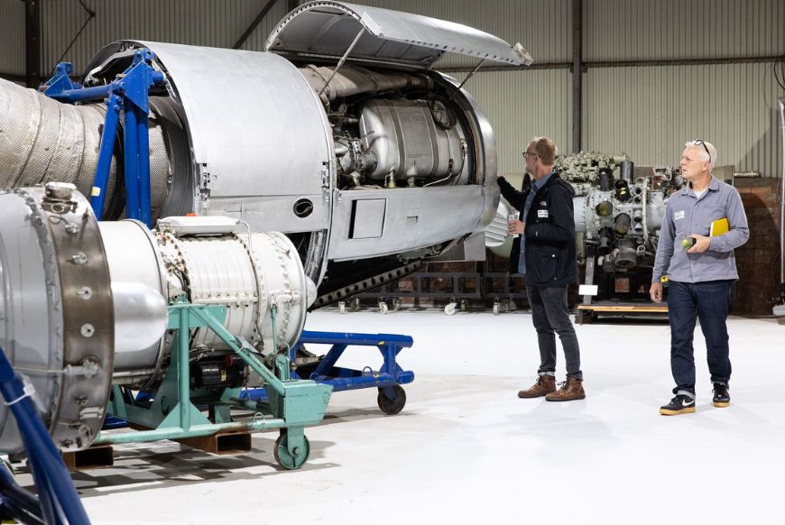 a big engine with two people looking at it