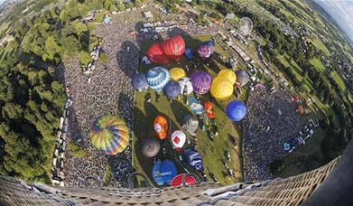 Balloons taking off, from the perspective of a balloon higher up in the air