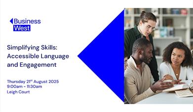 People sitting and standing around a table, discussing things