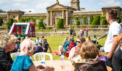People sat outside enjoying a festival 