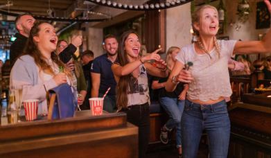 Group of people playing Darts