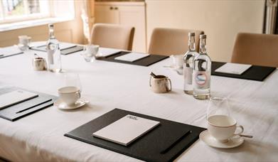 Cups and bottles set up on table
