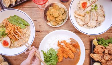 Various dishes at Tonkotsu such as karaage (fried chicken), curry and tempura, ramen, and more