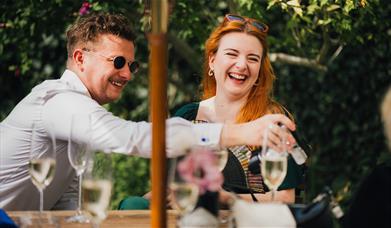 Summer party guests having drinks outside