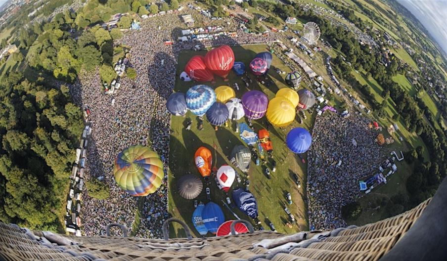 Balloons taking off, from the perspective of a balloon higher up in the air
