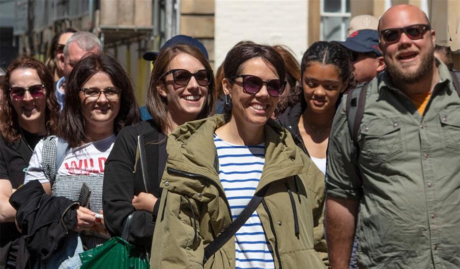 Luke leading a tour with people laughing and enjoying the Blackbeard to Banksy tour