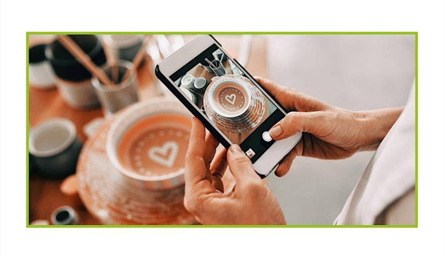 a photo of someone using their phone to take a photo of some pottery