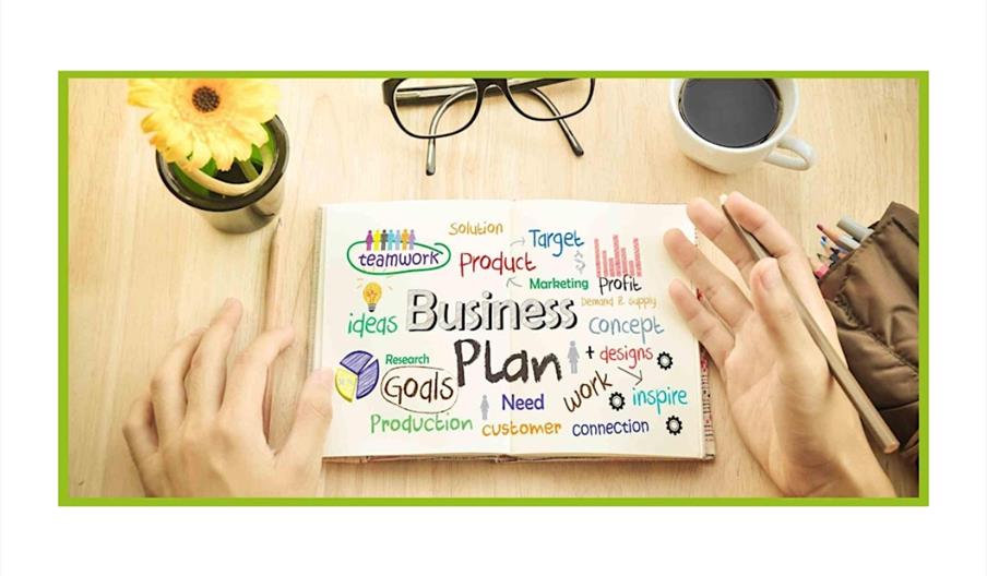 Stock photo of items on a table like someone's hands, glasses, and a page called Business Plan
