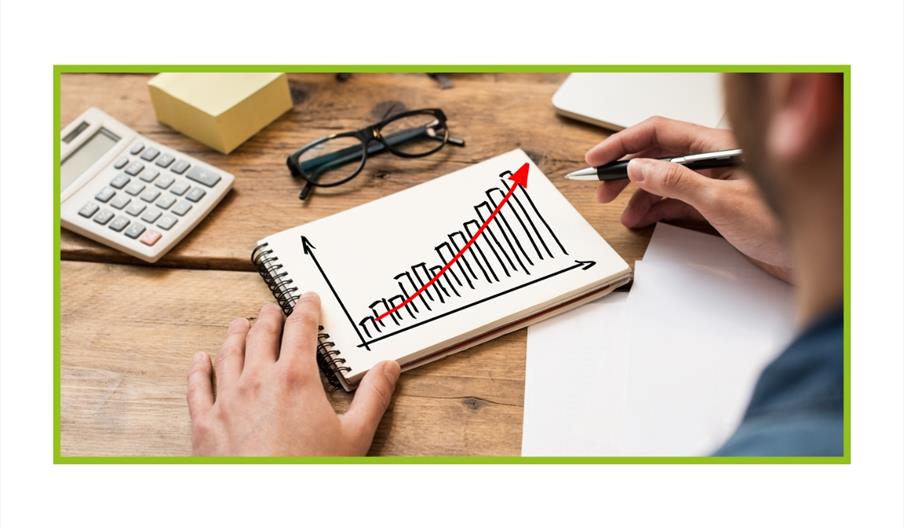 Person drawing a bar graph going up