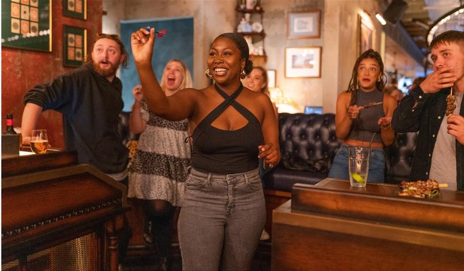 person throwing darts