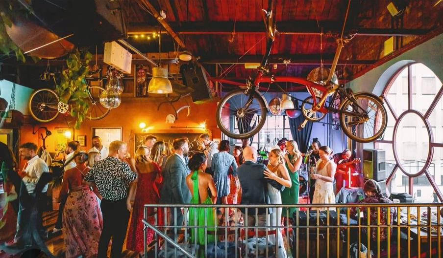 Mud Dock interior standing party with people dancing