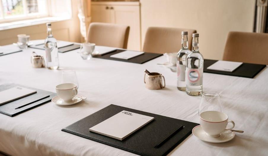 Cups and bottles set up on table