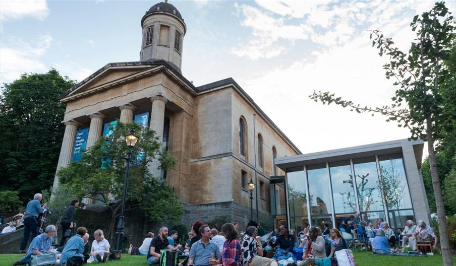 St George's Bristol exterior people sat on lawn
