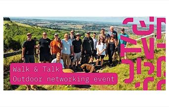 People posing for a group photo out in the countryside