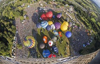 Balloons taking off, from the perspective of a balloon higher up in the air