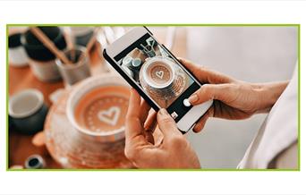 a photo of someone using their phone to take a photo of some pottery
