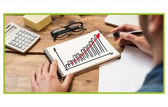 Person drawing a bar graph going up
