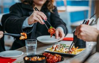 People eating with chopsticks