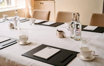 Cups and bottles set up on table