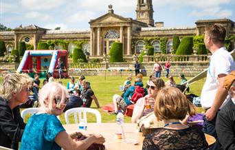 People sat outside enjoying a festival