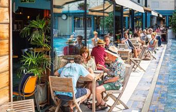 The Lido Restaurant people eating by the side of the pool