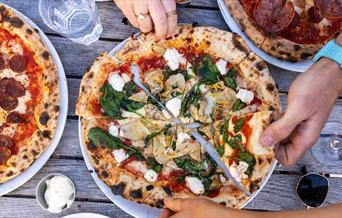 A spinach, artichoke and ricotta pizza