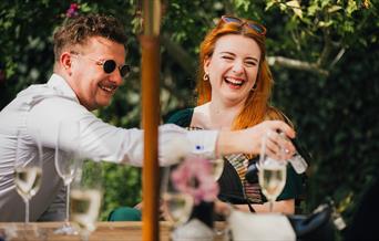 Summer party guests having drinks outside