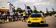 A yellow 2019 Honda Civic Type R on the racetrack at Haynes International Motor Museum