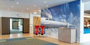 Holiday Inn Bristol Filton foyer, reception area with Concorde chairs and images on display.