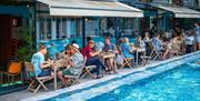People enjoying meal by the pool at Bristol Lido
