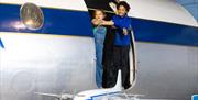 children looking outside plane
