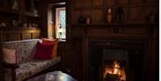 Interior of a cosy room at Berwick with a couch and a fire