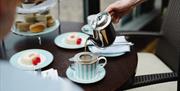 Hand pouring tea