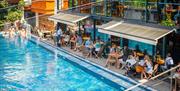 Bristol Lido poolside with people on chairs