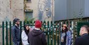 Cyclers beside the Girl with a Pierced Eardrum by Banksy