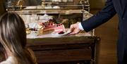 A dessert trolley laden with cakes at the Emberwood brasserie in Bath city centre