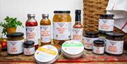 Shot of jars of eggs, spreads, chutneys, and bottles of sauces