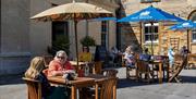Hartham Park courtyard people seated at picnic tables