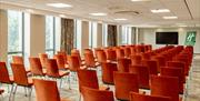 Conference room arranged theatre style seating with a central aisle