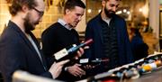 People inspecting bottles of wine