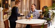 People being served cocktails
