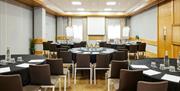 Conference room set up with several round tables