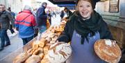 Woman at bakery market stall
