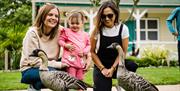 Parents and child with geese