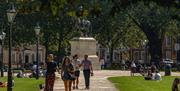 People walking in Queen Square in Bristol