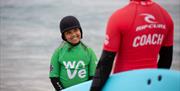 Child looking at coaches at The Wave