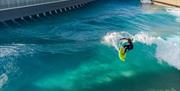 Person surfing in Bristol at The Wave drone shot