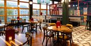 Interior shot of seating, batting cage, and window view of the harbourside