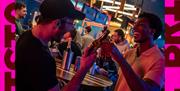 Two people cheersing bottles of beer